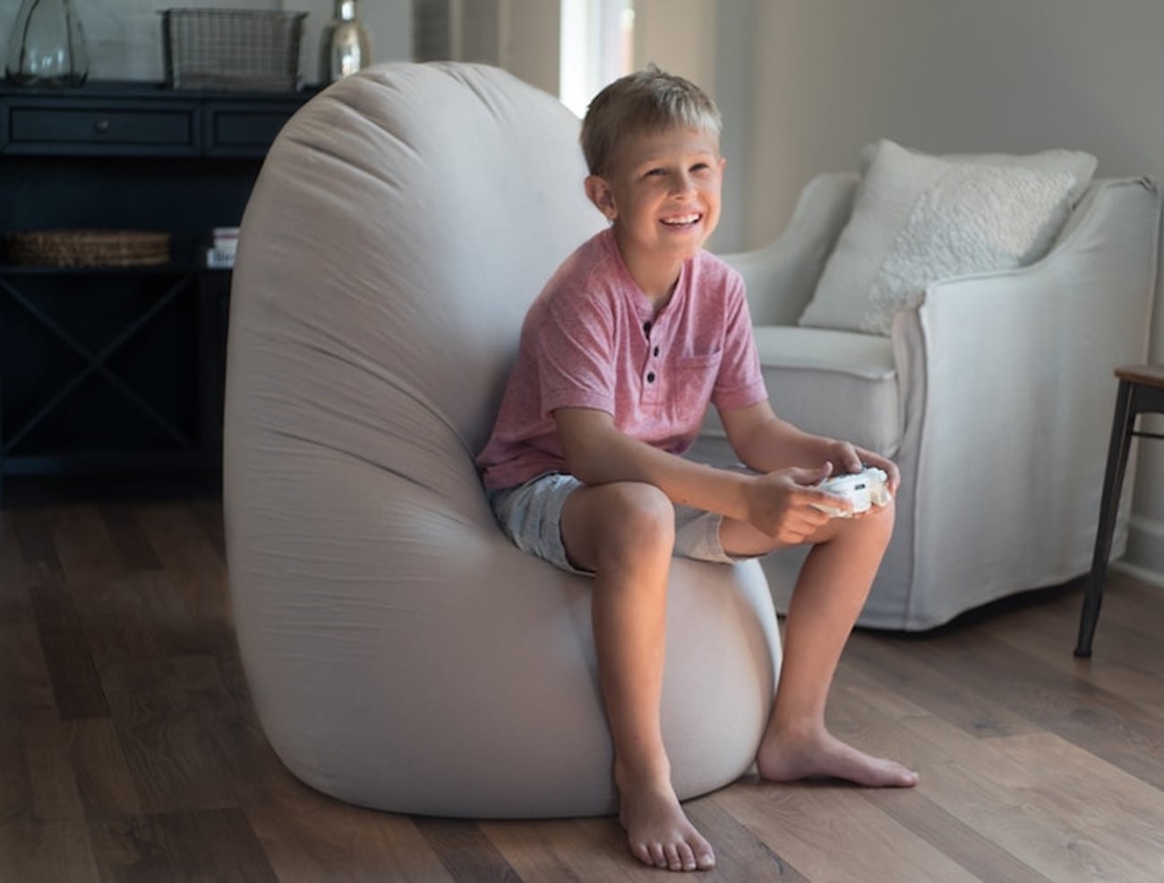Child sitting on a bean bag chair in a living room