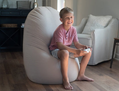 Child sitting on a bean bag chair in a living room
