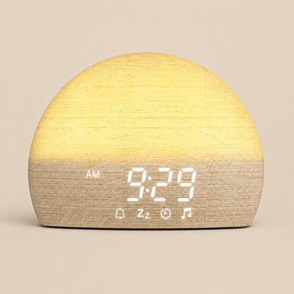 A dome-shaped digital alarm clock with a two-tone wood-grain finish, glowing with warm yellow light on top and beige on the bottom. The digital display shows '9:29 AM' with icons for bells, sleep mode, timer, and music.