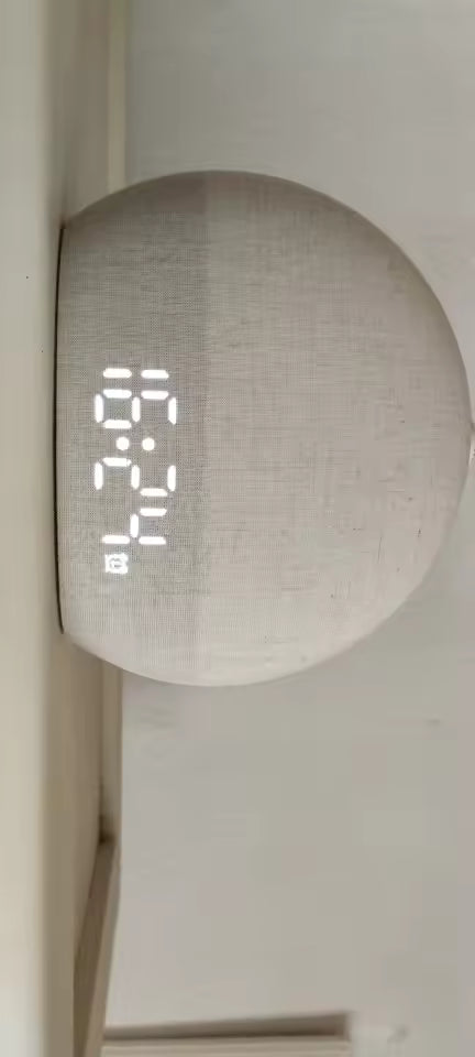 Digital clock displaying time on a plain background
