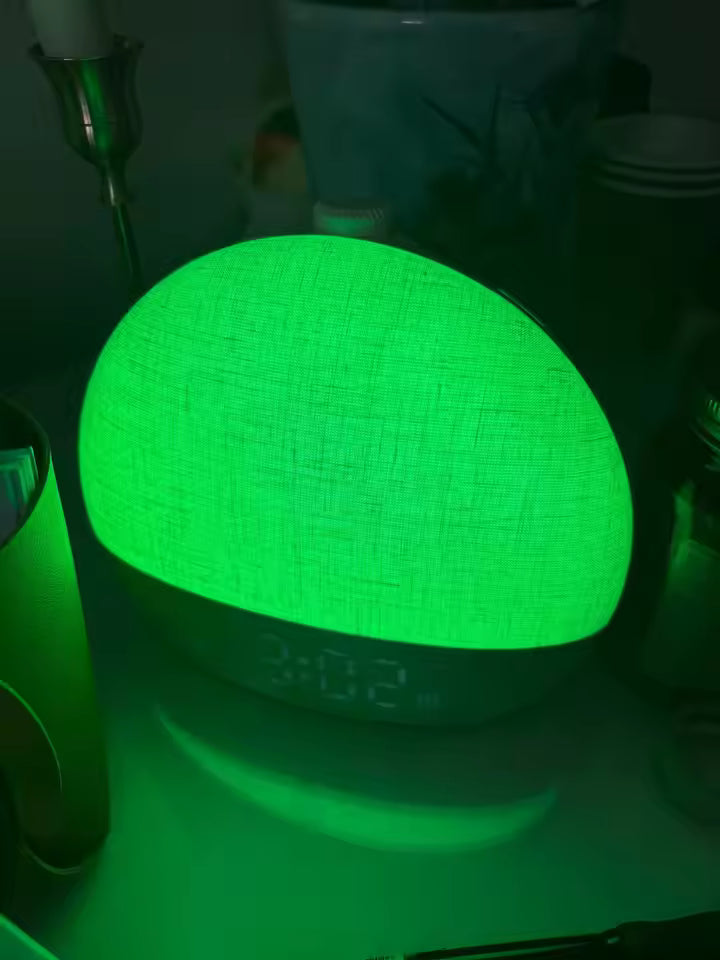 A dome-shaped fabric lamp glowing bright green in a dim room, with a digital clock display showing 3:02 on the front.